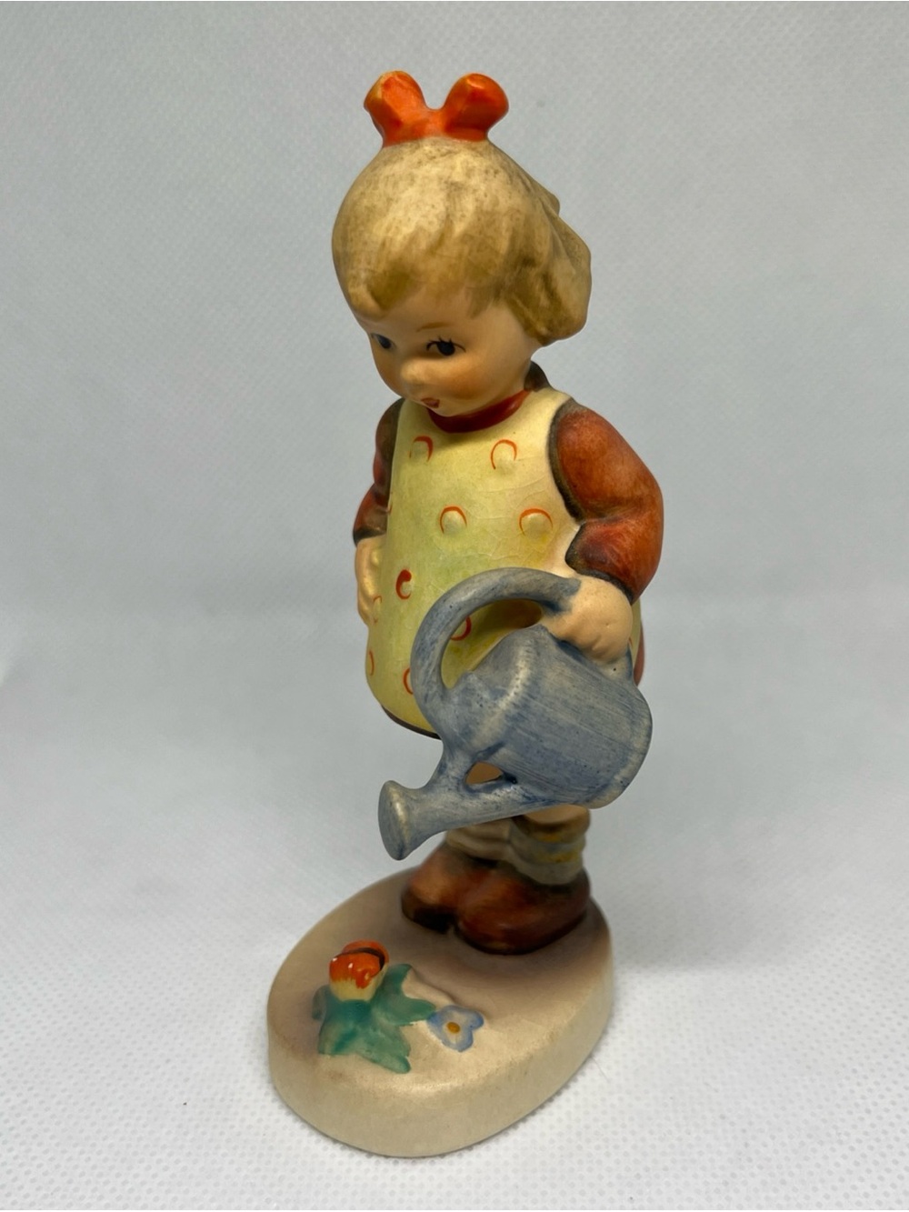 Hummel Girl Figurine with Yellow Apron‎ and Blue Watering Can